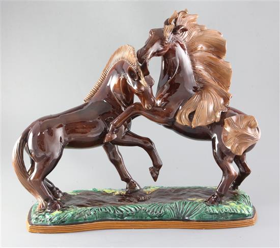 R. Prunet. A tin glazed terracotta group of two mustangs, width 22in. height 19in.